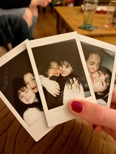 four polaroid photos being held by a woman's hand in a living room