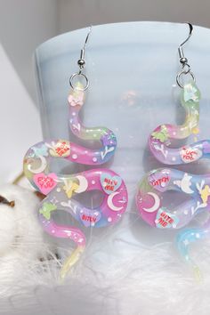 💖 Not all love stories end happily ever after 💔. So, why should your style? Show your unique taste with our Handmade Anti Valentines Snake Earring. Crafted from resin jewelry, these badass accessories will have everyone's heads turning. Perfect for a night out or a statement piece for your day-to-day look. 🐍 Whimsical Multicolor Sterling Silver Jewelry, Multicolor Single Earring Jewelry Gift, Multicolor Single Earring As Gift, Whimsical Drop Earrings, Whimsical Sterling Silver Hypoallergenic Jewelry, Whimsical Sterling Silver Drop Earrings, Cute Single Earring Jewelry As Gift, Whimsical Dangle Jewelry For Gifts, Whimsical Dangle Jewelry Gift