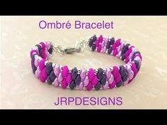 an image of a bracelet made with purple, pink and silver beads on a white background