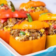 stuffed peppers with meat and vegetables in a blue casserole dish