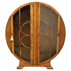 a wooden display case with glass doors on the front and sides, in an oval shape