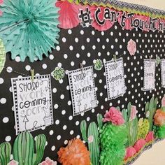 a bulletin board is decorated with flowers and cactuses for teachers to display their classroom's art work