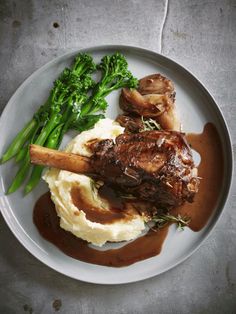 a plate with mashed potatoes, broccoli and meat