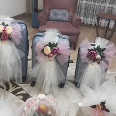 four pieces of luggage with tulle and flowers on them sitting on the floor in front of a chair