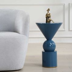 a blue vase sitting next to a white chair