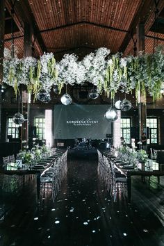 an indoor venue with tables and chairs set up for a formal function in front of a large screen