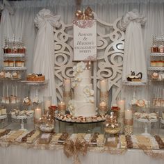 a table topped with a white cake and lots of cupcakes