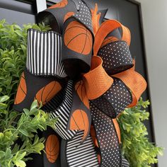 an orange and black wreath with basketballs on it