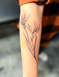 a woman's arm with a flower tattoo on the left side of her body