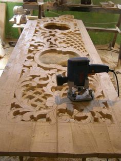 a table that has been made with wood and is being worked on by a machine