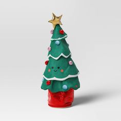 a green christmas tree sitting on top of a red container