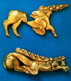 two gold brooches, one with a horse and the other with a dog