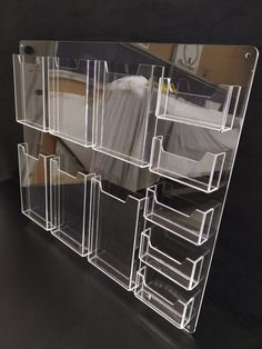 an acrylic display case with multiple drawers on the front and back sides is shown