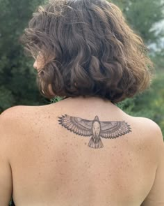 a woman with a bird tattoo on her back