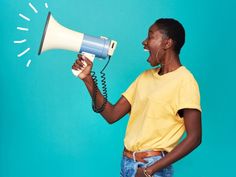 a woman holding a megaphone up to her face and yelling into it with the horn