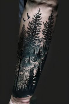 a man's arm with trees and birds on it