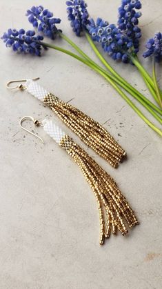 Tube Bead Earrings, White Tassel Earrings With Latkans As Gift, White Tassel Earrings With Latkans For Gift, Elegant Gold Tassel Earrings With Round Beads, Gold Tassel Earrings With Round Beads, Elegant Tassel Earrings With Round Beads, Elegant Adjustable Tassel Earrings With Round Beads, Gold Beaded Dangle Earrings With Tassels, Elegant Handmade Adjustable Tassel Earrings