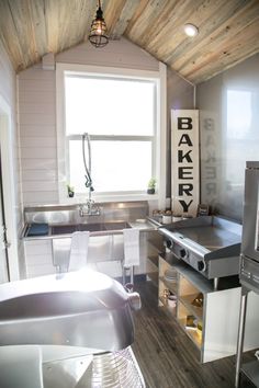 a kitchen with an oven, sink and refrigerator in it's center island next to a window