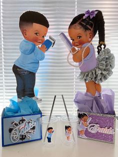 a couple of dolls sitting on top of a table