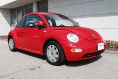 a red car parked in front of a building