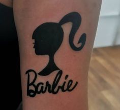 a woman's arm with the word barbie on it