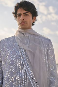 This set features all over mirror work on a raw silk base. It is paired with a grey silk kurta and white straght pant. Complementing stole is also available.From Seema Gujral's Elements collection. DELIVERY TIMEPlease allow 6-8 weeks for your outfit to arrive. FABRIC DETAILSSherwani - Raw Silk Kurta - Silk Trouser - Cotton Dupatta - Tissue Organza Professional cleaning only. Mirror Work Kurta For Men, Grey Sherwani, White Straight Pants, Groom Trends, Ladies Kitty Party Games, Raw Silk Kurta, Organza Kurta, Indian Wedding Clothes For Men, Vogue Arabia