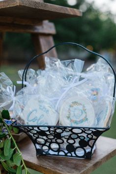 a basket filled with cookies sitting on top of a wooden table