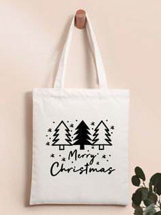 a white bag with merry christmas trees on it next to a potted green plant