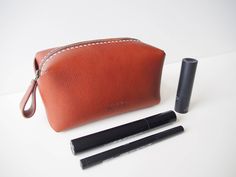 "Simple yet unique design zipper pouch. You can carry all of your essential stuffs. - 100% Vegetable tanned leather - Hand stitched with waxed thread - Edges are burnished to smooth sheen - YKK metal zipper - Comes with 100% cotton bag Approximate Dimensions: W 6.25\" x H 3.50\" x D 2.75'' W 16cm x H 9cm x D 7cm Zipper length: 8\" 20cm Personalisation (optional) - Complimentary personalisation is available. - You can chose up to 6 letters (capital alphabet only (6mm height). include 'space' and Leather Cosmetic Bag For Daily Use, Leather Cosmetic Bag With Zipper For Daily Use, Leather Zipper Pouch Cosmetic Bag For Daily Use, Leather Zipper Pouch Cosmetic Bag For Everyday, Everyday Leather Cosmetic Bag With Zipper Pocket, Leather Cosmetic Bag With Zipper Pocket, Leather Cosmetic Bag With Zipper Closure, Leather Cosmetic Bag With Zipper Closure As Gift, Soft Leather Pouch For Personal Use