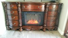 an old dresser has a fire place in it