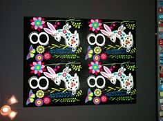 an image of a rabbit with flowers and butterflies on it's back wall hanging