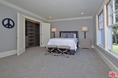 a bedroom with gray walls and carpeted flooring