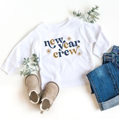 New Year Crew! Navy and Gold Print Fabric: 100% Cotton Wash: For best results wash inside out on cold and line dry. DO NOT IRON directly on the image All our designs are printed with high quality heat transfer vinyl. The designs are applied using a professional commercial grade heat press and are made to last. All items are made to order in the order in which they are received so please allow 5 business days for your order to be shipped out.  Business days include: Monday - Friday Business days White Crew Neck T-shirt For New Year, New Year’s Eve Shirts, New Years Toddler Shirt, New Year’s Eve Disney Shirts, Diy Onesie, New Year Holiday Crew Neck T-shirt, New Years Eve Shirt, Onesie Ideas, Kids New Years Eve