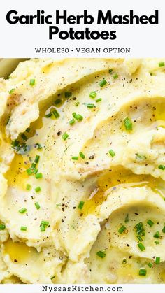 garlic herb mashed potatoes in a bowl with green onions and parsley on top