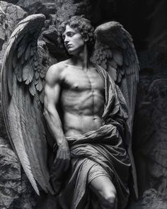 a black and white photo of a man with angel wings on his chest sitting in front of a stone wall