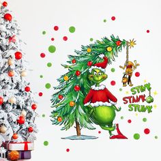 an image of a christmas tree with the grin's stuck on it and other holiday decorations