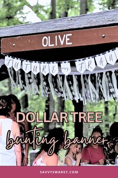 people are standing under a dollar tree with bunting banners hanging from it's roof