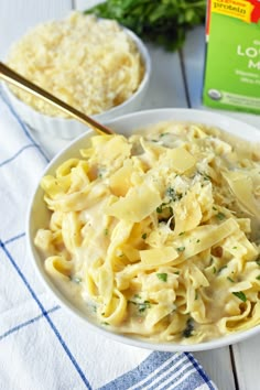 a white bowl filled with pasta and cheese