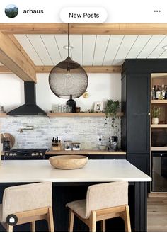 the kitchen is clean and ready to be used for cooking or baking, with two stools in front of the island