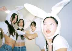 four girls in bunny ears are posing for the camera