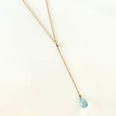 A 2-carat faceted tear-drop shaped Aquamarines sparkles on a dainty cable chain in sterling silver, rose, or yellow gold filled. The Aquamarine Drop is available with an adjustable 16 to 18-inch chain.Great for everyday wear, bridal jewelry or give it as a gift for that someone special! Aquamarine Teardrop shape, faceted "briolette" measures 9 x 6 mm or more weighs 2 + carat colors range from light to medium greenish/blue eye-visible inclusions Chain length 16 to 18inch adjustable Made to Order: Adjustable Teardrop Lariat Necklace, Adjustable Teardrop Lariat Necklace With Delicate Chain, Teardrop Lariat Necklace With Delicate Chain As Gift, Teardrop Lariat Necklace With Delicate Chain For Gifts, Fine Jewelry Teardrop Lariat Necklace, Fine Jewelry Teardrop Lariat Necklace Gift, Dainty Teardrop Lariat Necklace Gift, Briolette Lariat Necklace With Adjustable Chain As Gift, Grey Diamond Engagement Ring