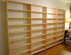 empty bookshelves in a room with hard wood floors