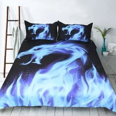 a bed covered in blue and black sheets with fire flames on the cover, next to a ladder