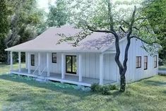 a small white house sitting on top of a lush green field next to a tree