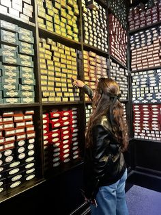 a woman is looking at some type of wall display