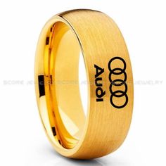 an engraved gold ring with the number one on it and two rings in black lettering