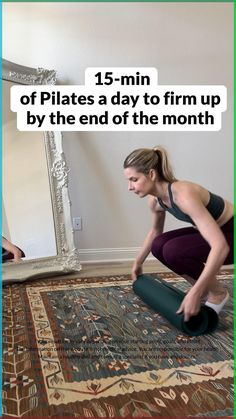 a woman kneeling down on her yoga mat in front of a mirror with the text, 15 - min of pilates a day to firm up by the end of the month