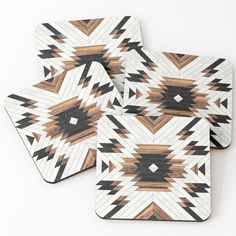 four coasters with brown and black designs on them