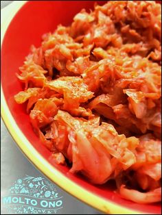 a red bowl filled with food on top of a table