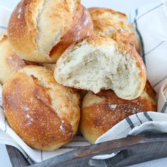 a basket filled with rolls sitting on top of a table